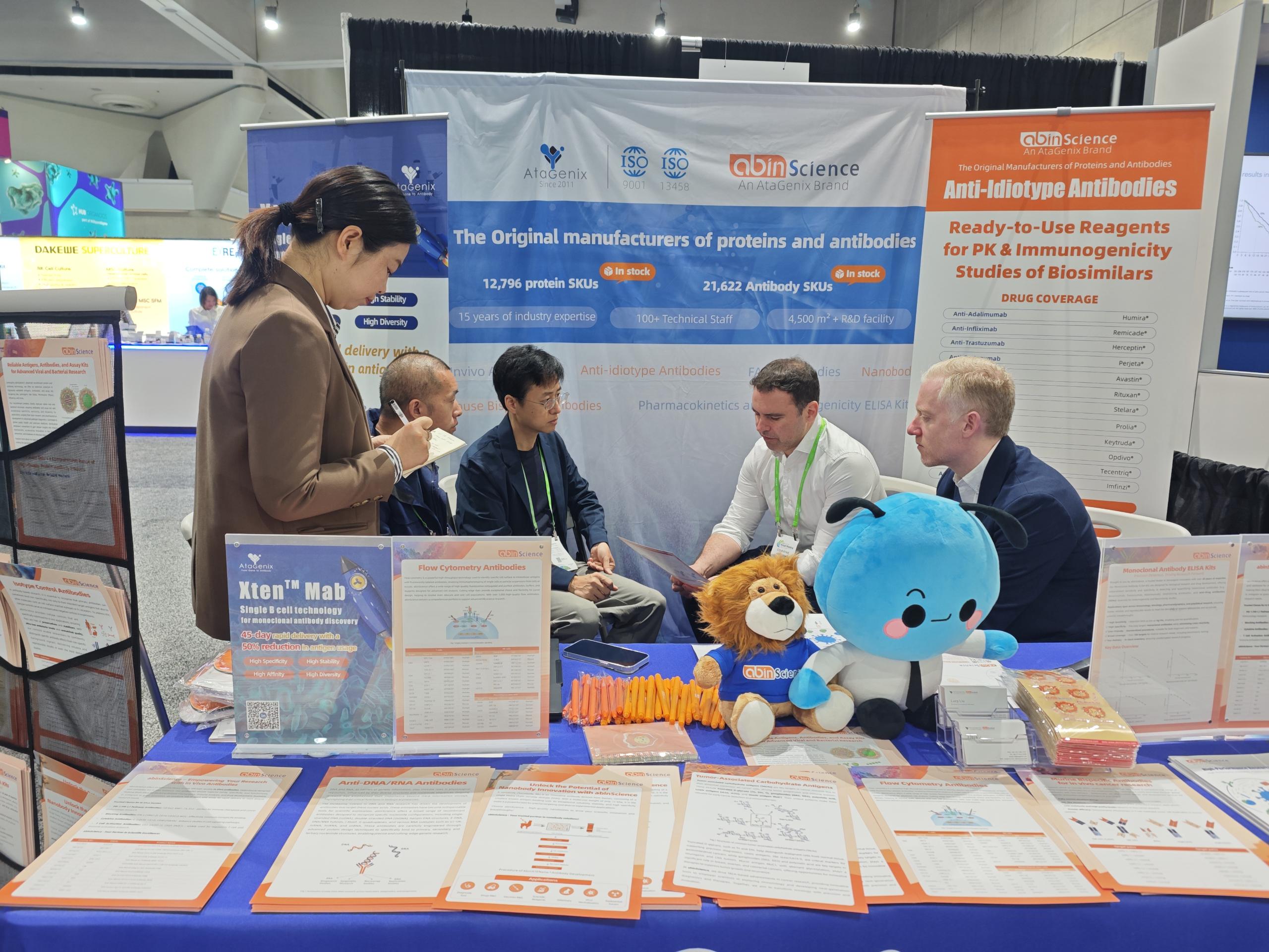 AtaGenix team discussing custom antibody solutions with researchers at AACR 2026